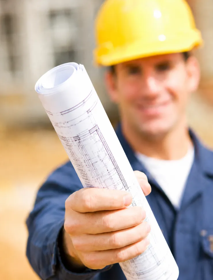 Los Angeles construction professional holding blueprints for a remodeling and ADU project