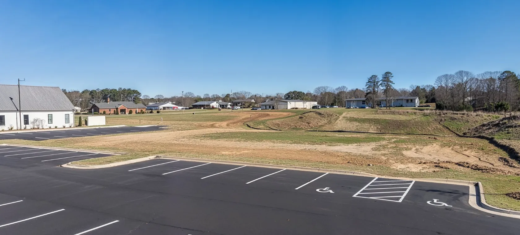 Before commercial construction project in Los Angeles showing a vacant development site with parking area, open land, grading space, and commercial building construction potential