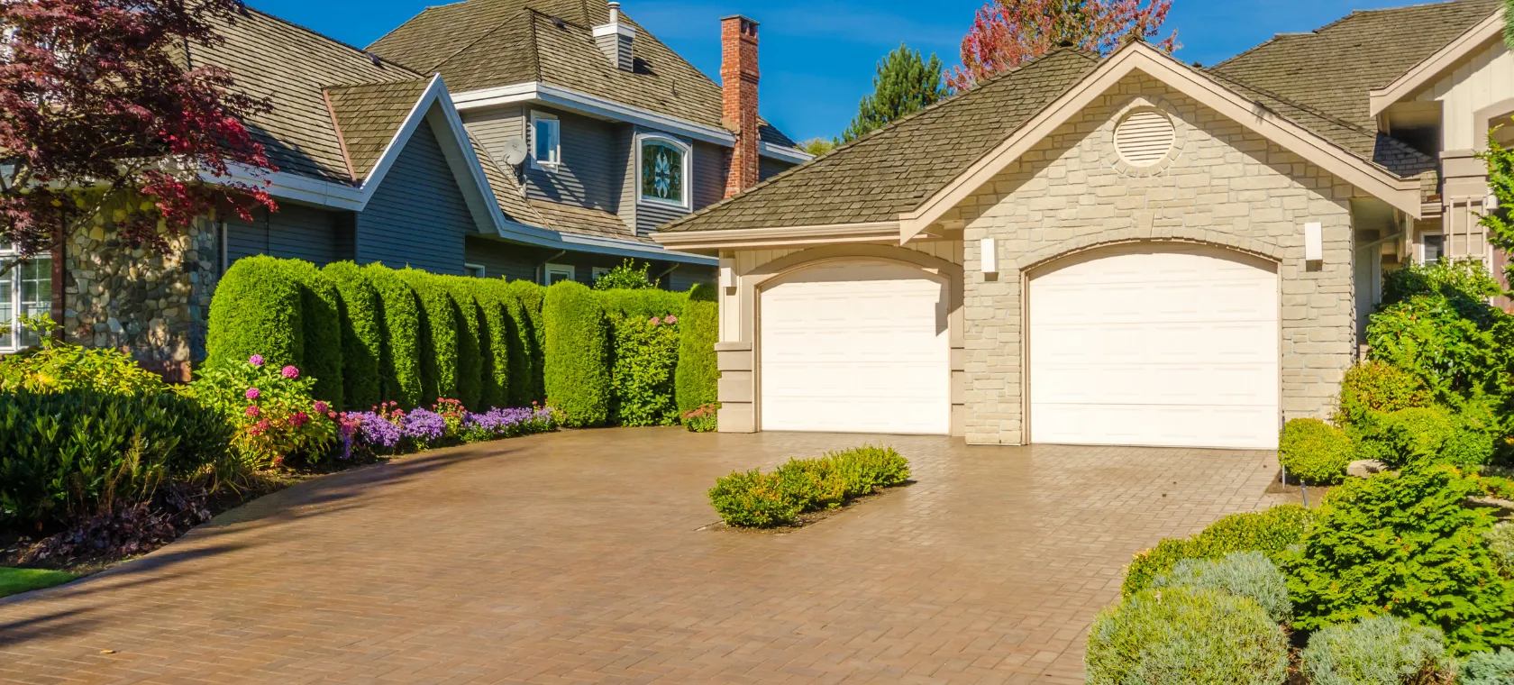 Before garage conversion ADU project in Los Angeles showing an existing detached garage structure with driveway, landscaping, garage doors, and residential conversion potential