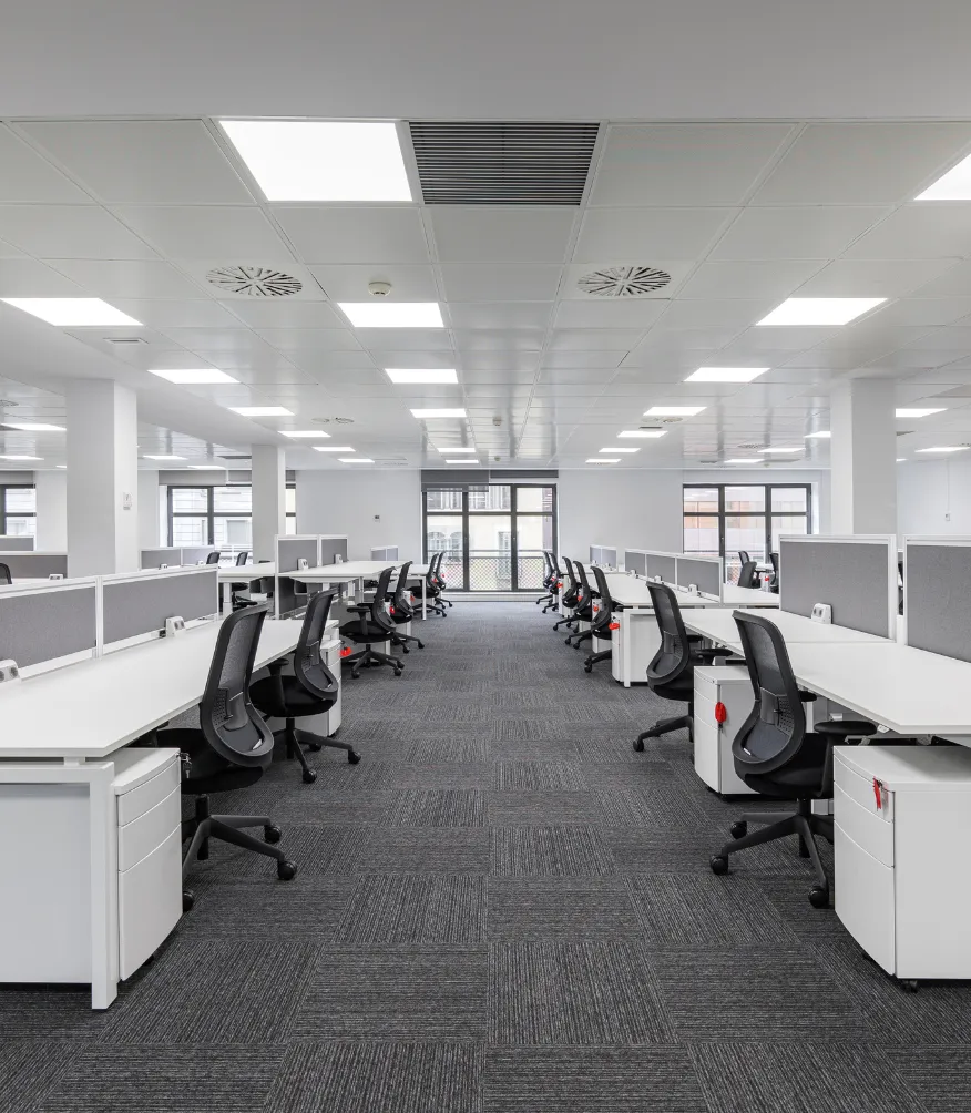 Commercial remodeling project in Los Angeles showing a modern office workspace with cubicles, ceiling lighting, carpet flooring, open layout, and professional tenant improvement design