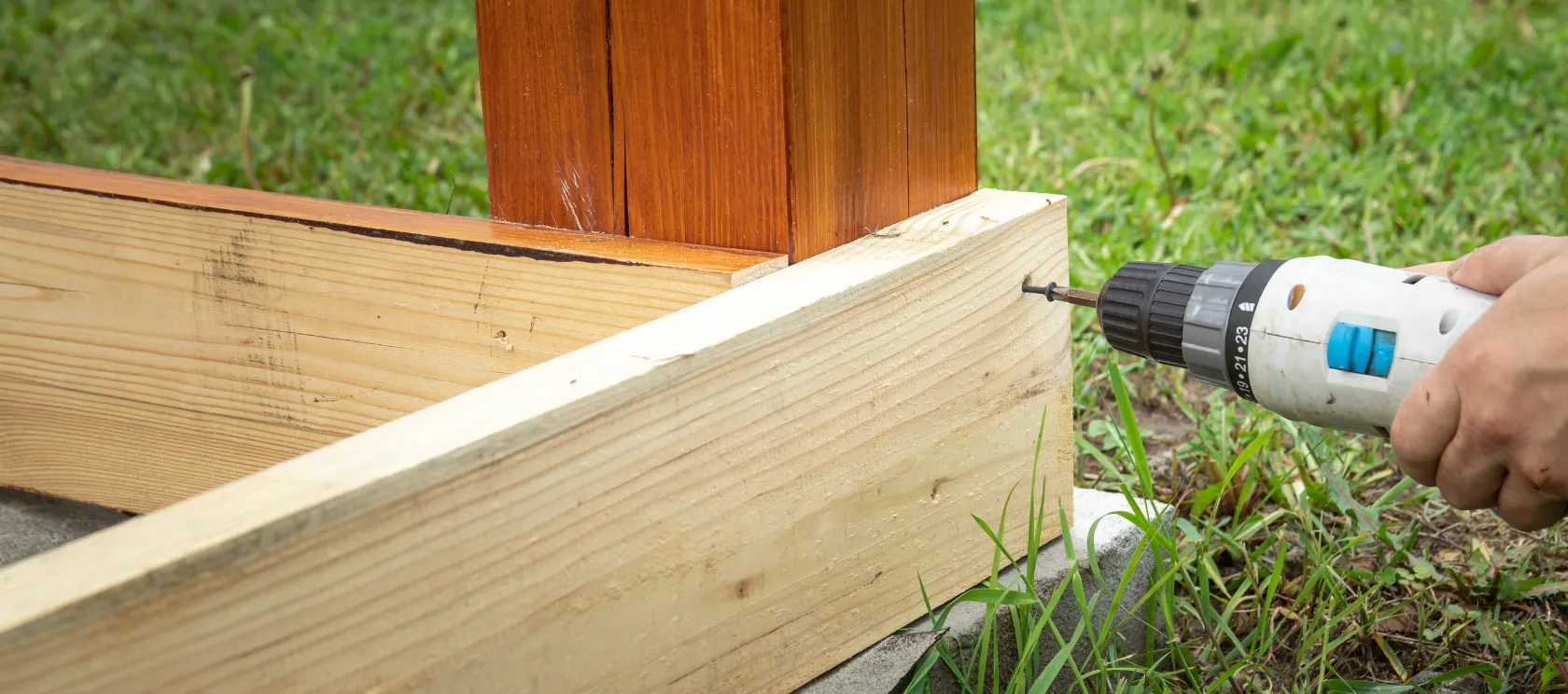 Backyard remodeling in Los Angeles showing wood deck framing installation, drill work, outdoor carpentry, and custom backyard improvement construction