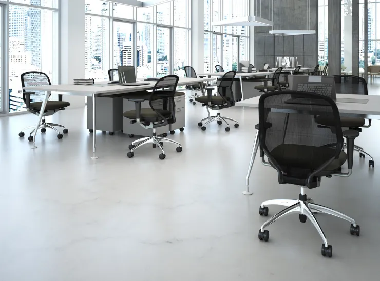 Commercial remodeling in Los Angeles showing a modern office interior with open workspace layout, large windows, desks, task seating, and finished flooring